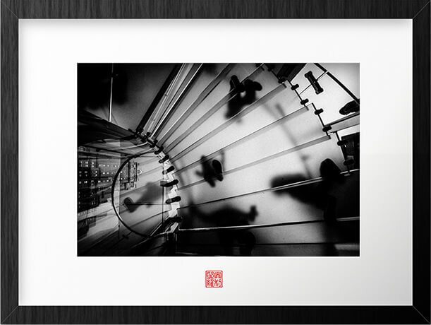 Framed street photograph of a spiral staircase