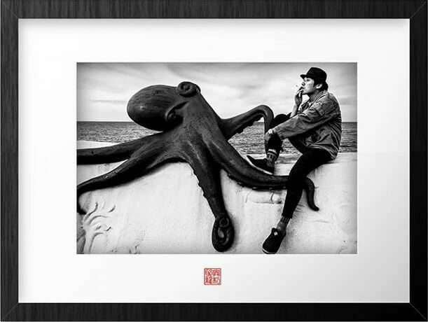 Framed street photograph of a man reading